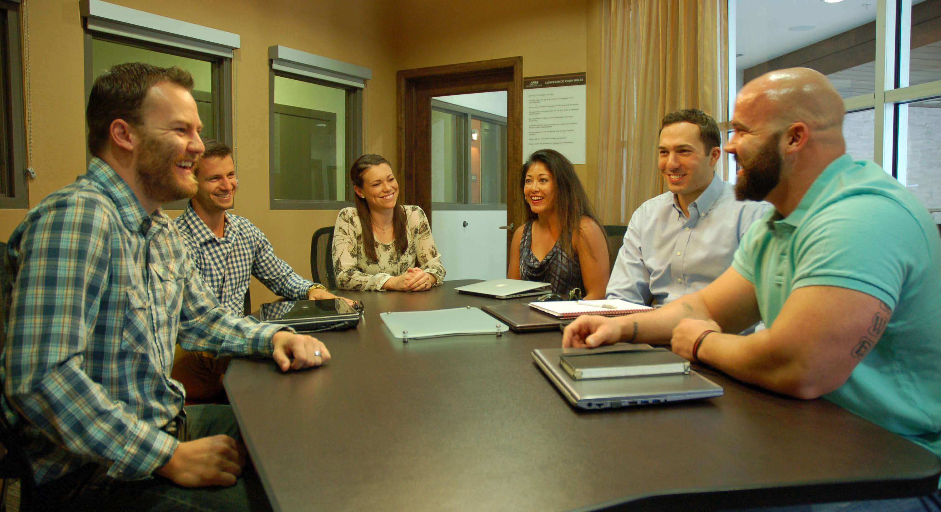 Matt (far right) and Amy Lowe (center left) start the day with their Denver-based business team.
