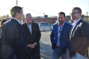 Mike Biselli (center right), the president of Catalyst HTI, speaks with attendees at the ground breaking.